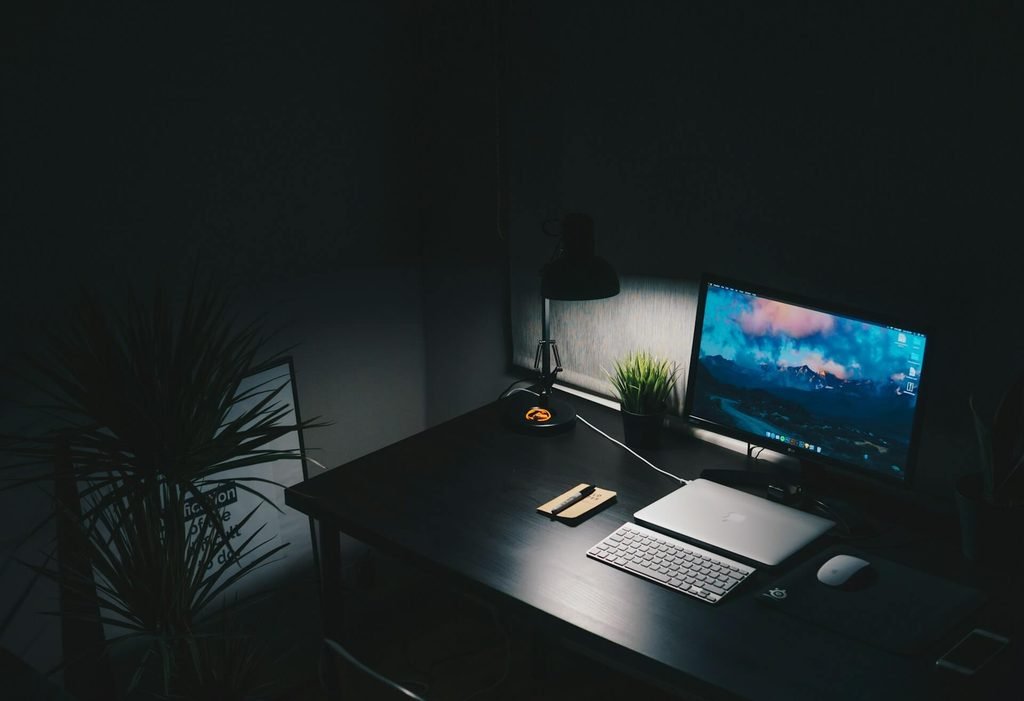 Minimalist home office desk setup with light bar