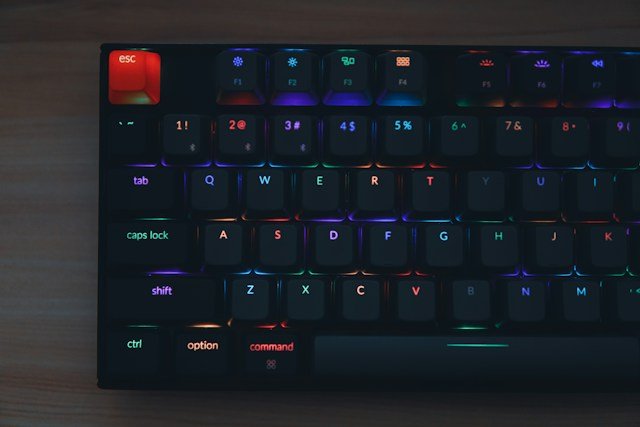 person typing on a mechanical keyboard with wrist rest